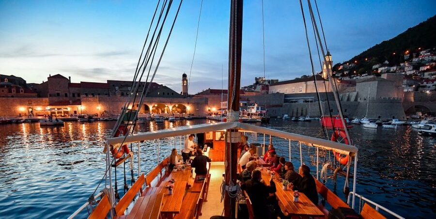 Dubrovnik: Sunset Dinner Cruise around the Old Town - Sunset, candles, and the City Walls after dark