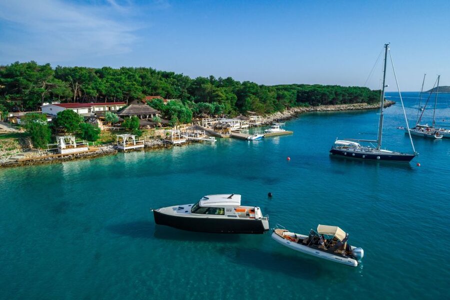 From Split: 3 Islands Half-Day Boat Tour with Blue Lagoon - Racing out toward Krknjaši Blue Lagoon