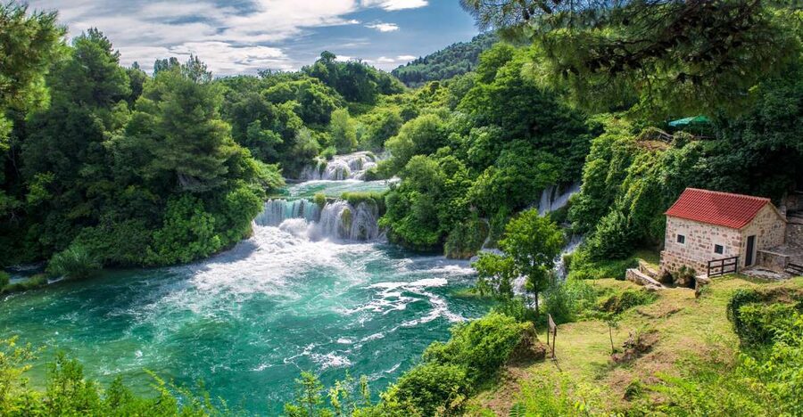 From Split: Krka Waterfalls Tour with Boat Ride & Swimming - Walking the wooden paths at Skradinski Buk
