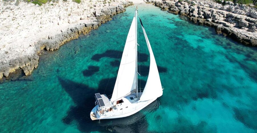 Hvar: Private Sailing Boat Trip with Swimming and Snorkeling - Sailing away from Hvar on a small private boat