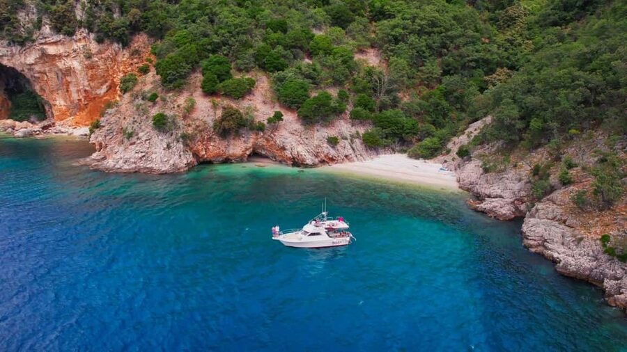 Opatija/Lovran: Boat Trip to Secluded Beaches on Island Cres - Brseč Beach starts the day with cliffs and clear water