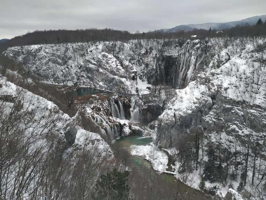 Plitvice Lakes: Guided Walking Tour with Boat Ride - Walking the wooden paths beside the falls