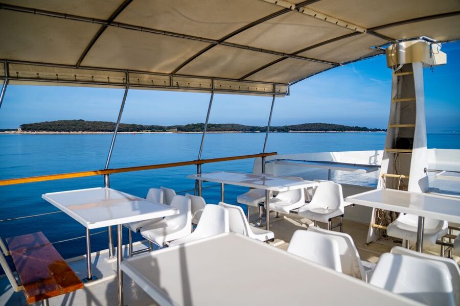 Pula: Brijuni National Park Sunset, Dolphins & Dinner Cruise - Sunset over the Adriatic and Pula after dark